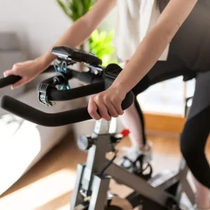 low-section-of-woman-training-on-exercise-bike-at-royalty-free-image-1678134200